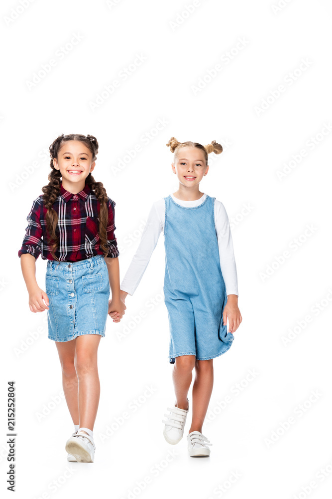 schoolchildren walking and holding hands isolated on white schoolchildren walking and holding hands isolated on white