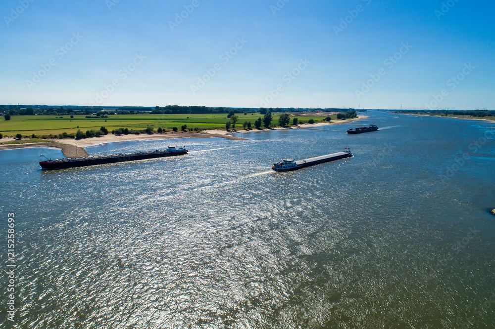 aerial view commercial ship crossing the River Rhine in an area of the Netherlands