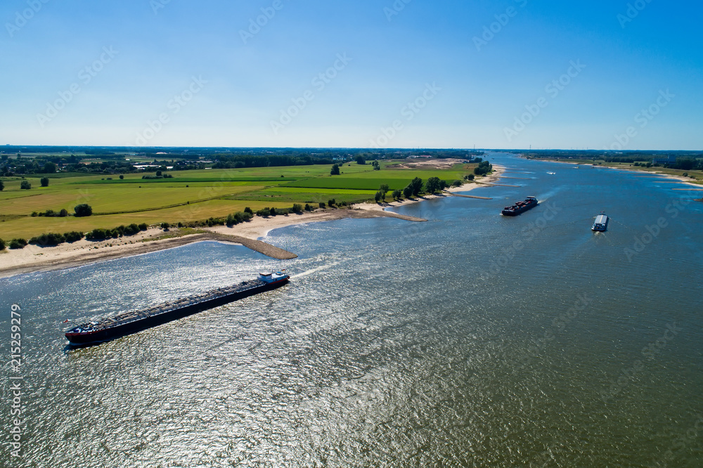 aerial view commercial ship crossing the River Rhine in an area of the Netherlands