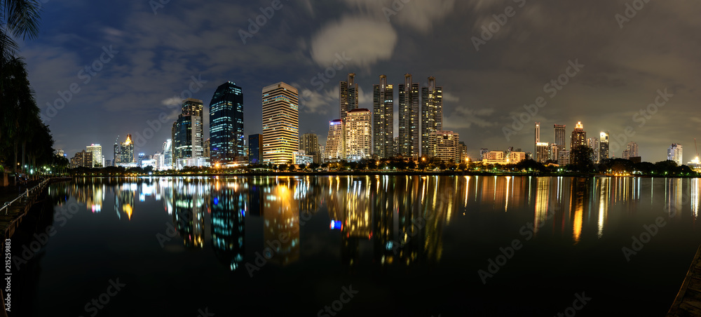 Panorama View, Modern buildings of Benchakitti Park with lights reflection in night city
