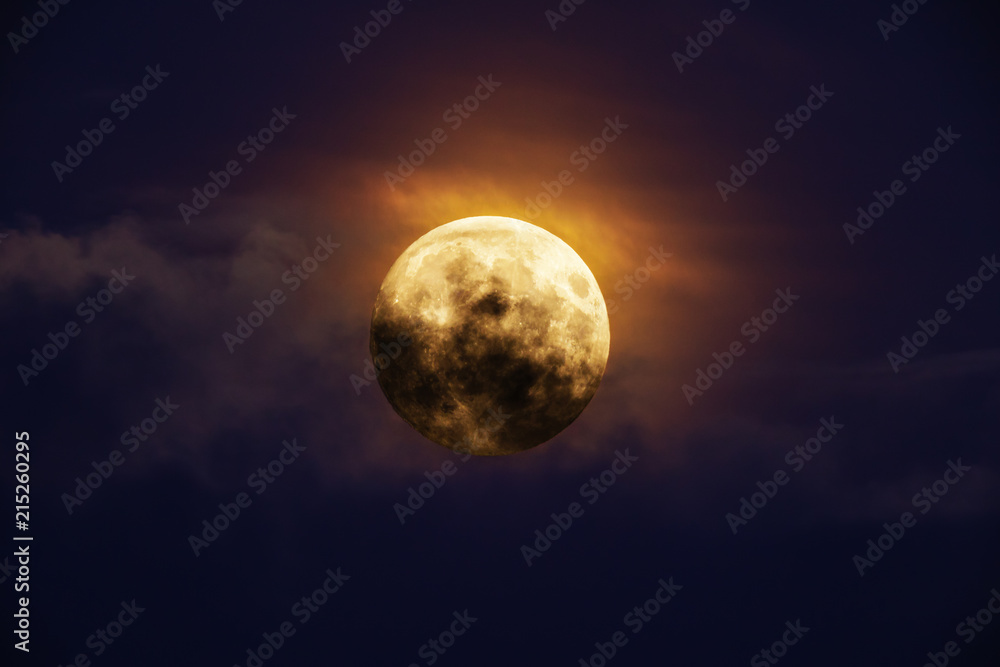 Fototapeta premium Bright full moon against dark clouds vibrant colors