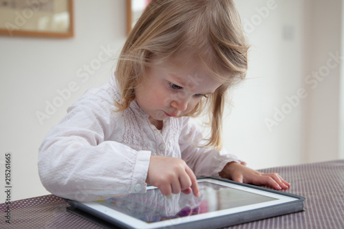 Female toddler playing on a tablet