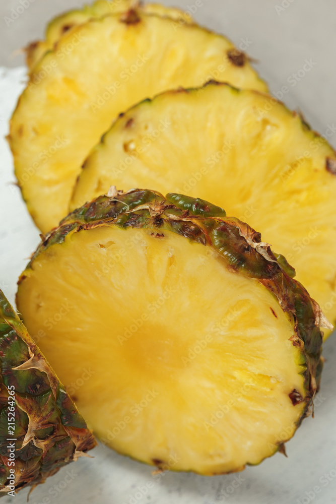 Fresh sliced pineapple on a cutting board Fresh sliced pineapple on a cutting board
