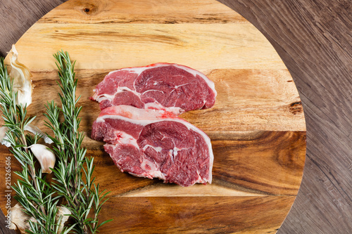 Raw lamb chump slices on chopping board