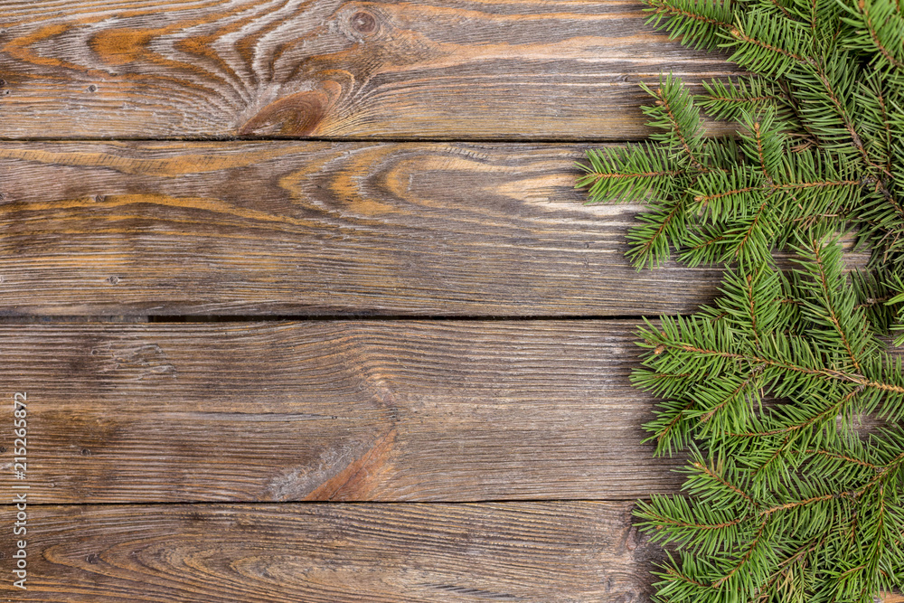 Christmas close-up of Christmas tree branches on vintage wooden background. Top view of a Christmas workplace. New Year frame or Xmas Mockup. Christmas close-up of Christmas tree branches on vintage wooden background. Top view of a Christmas workplace. New Year frame or Xmas Mockup.