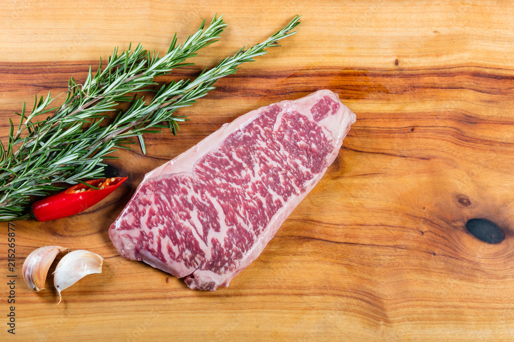 Raw beef wagyu sirloin steak on chopping board Raw beef wagyu sirloin steak on chopping board