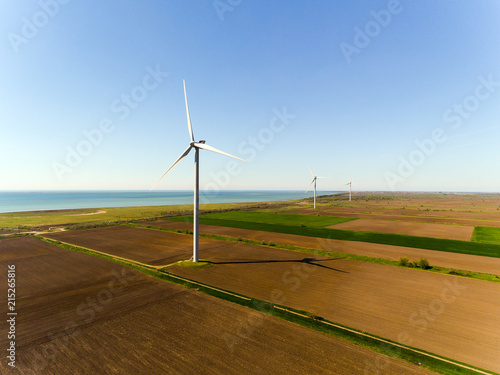 Aerial view looking across wind turbines in motion on a summers day