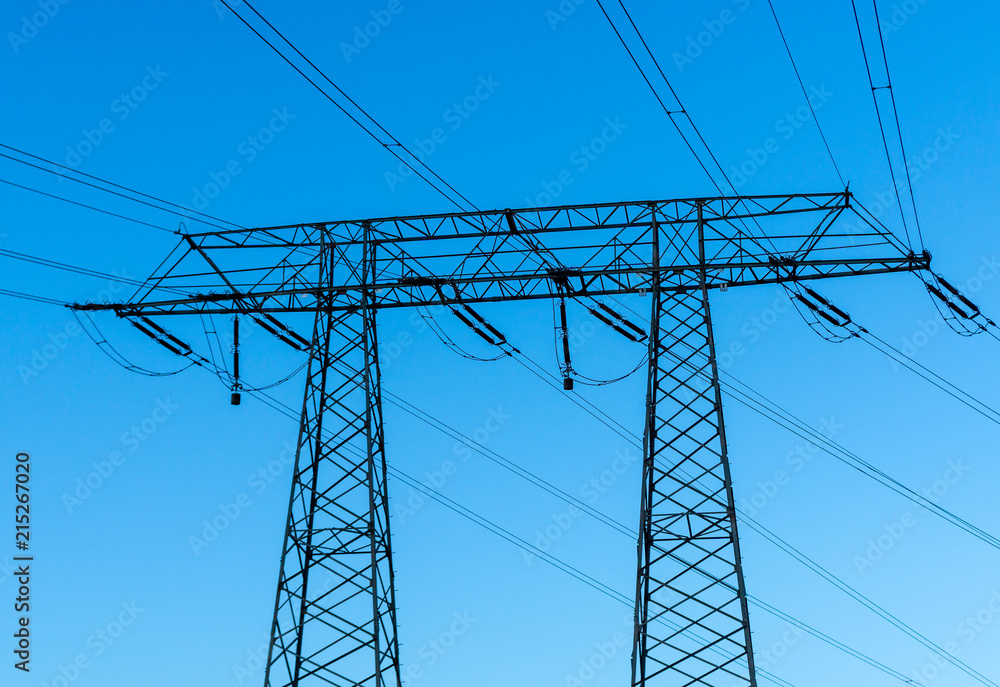 high voltage power lines and pole - blue sky