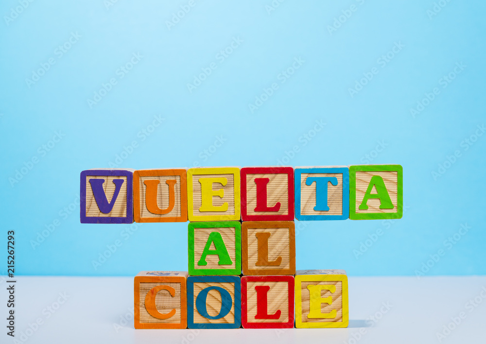 Back to School spelled out in Spanish language with wooden blocks Back to School spelled out in Spanish language with wooden blocks