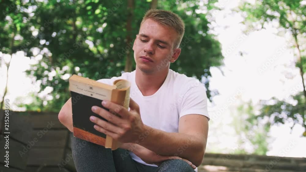 Portrait of young hipster man reading a book in the park Portrait of young hipster man reading a book in the park