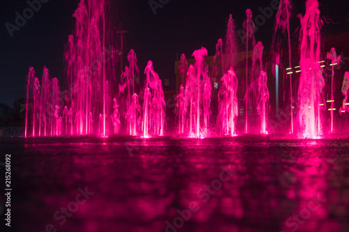 Fountain colored water show. Colorful fontain light in city. low angle.