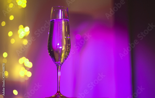 Champagne glass in disco party bar