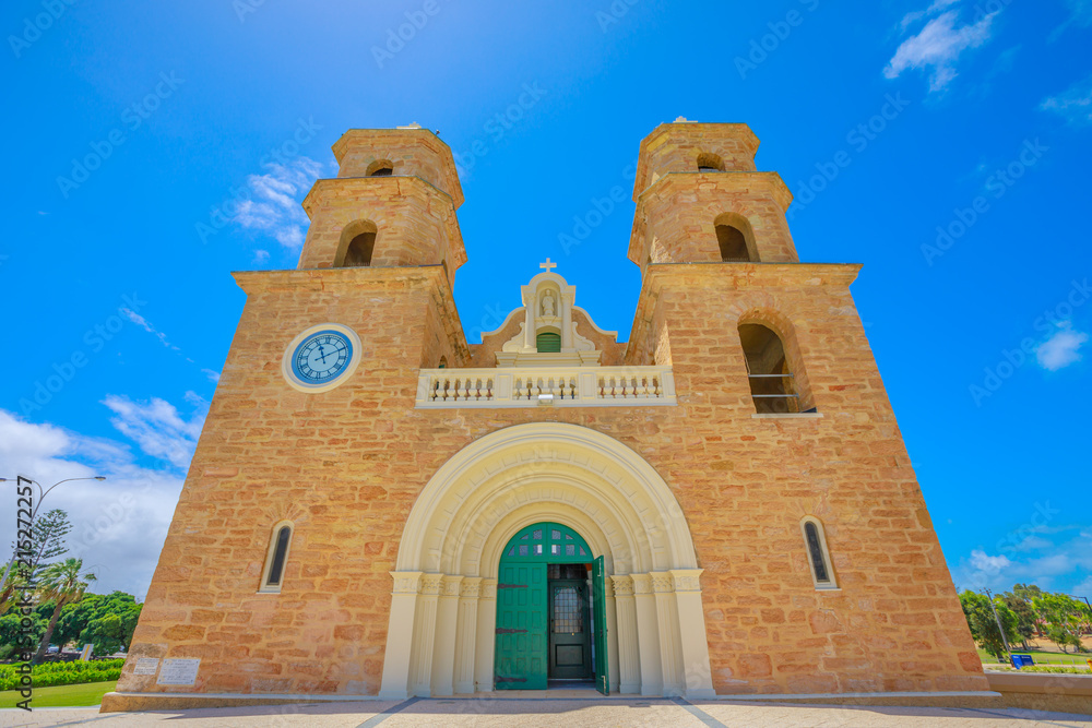 Front view of famous St. Francis Xavier's Cathedral with Twin Towers, the main place of Catholic worship in Geraldton, Western Australia. Geraldton Cathedral with sunny and blue sky. Copy space.