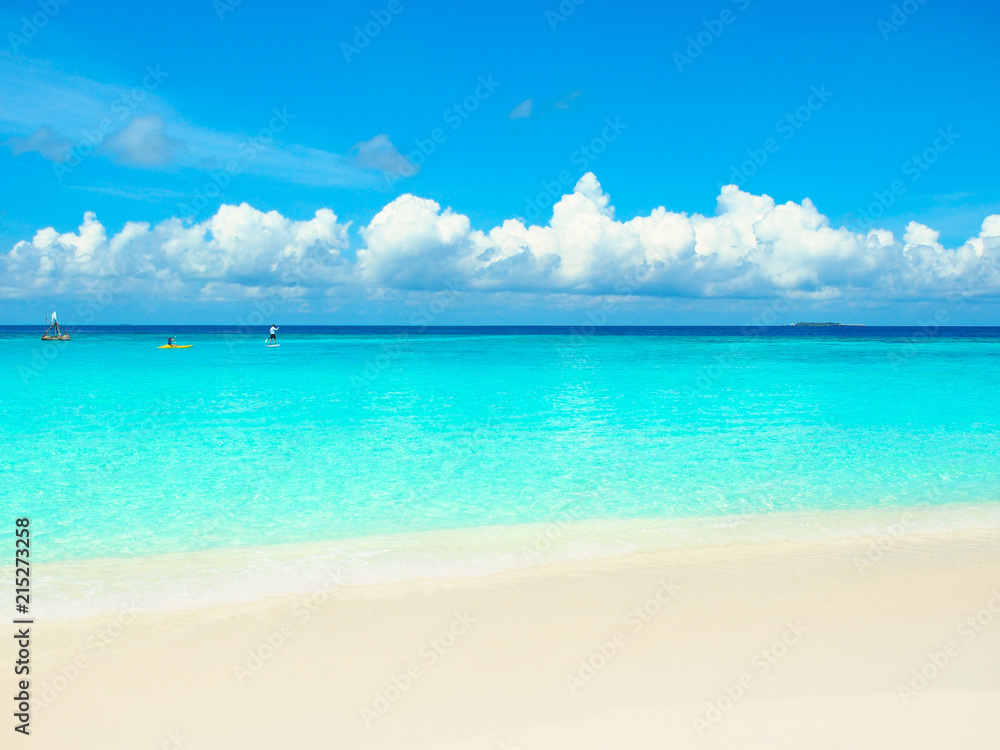 White sand beach,turquoise water sea and blue sky in Maldives island for summer vacations holiday concept.