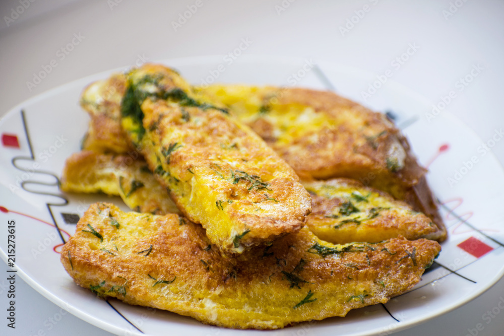 Fried bread in an egg with dill. Fried bread on a plate. Breakfast - bread and eggs. Fried bread in an egg with dill. Fried bread on a plate. Breakfast - bread and eggs.