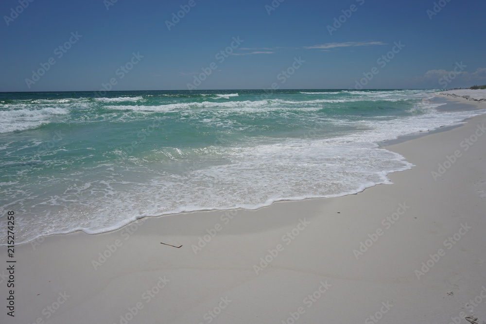 The wave hits the white sand beach in the day of nice weather and nobody there Panama City Beach, Spring in Florida USA. The wave hits the white sand beach in the day of nice weather and nobody there Panama City Beach, Spring in Florida USA.