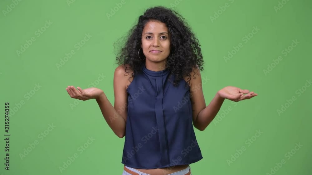 Young beautiful Hispanic businesswoman shrugging shoulders Young beautiful Hispanic businesswoman shrugging shoulders
