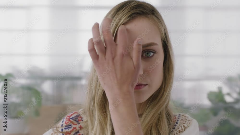 close up portrait of beautiful young blonde woman intern looking at camera running hand through hair in office workspace background close up portrait of beautiful young blonde woman intern looking at camera running hand through hair in office workspace background
