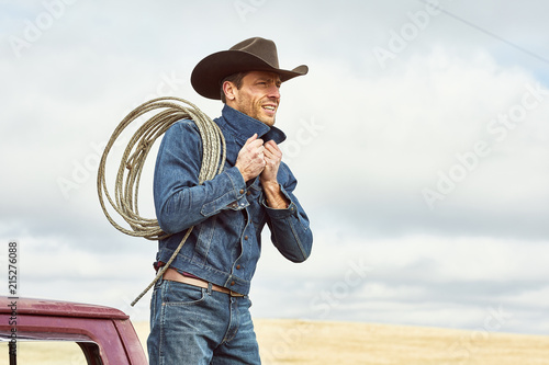 Cowboy with a rope over his shoulding photo