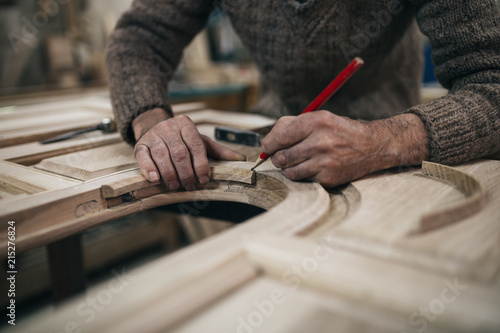 Canvas Print Close up shot of old master carpenter working in his woodwork or workshop