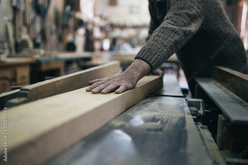 Close up shot of old master carpenter working in his woodwork or workshop Close up shot of old master carpenter working in his woodwork or workshop