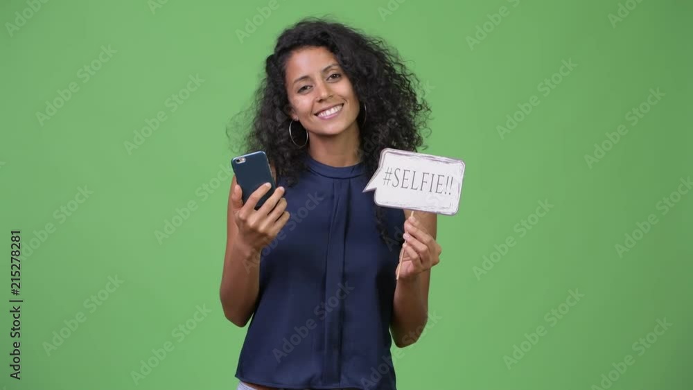 Young beautiful Hispanic businesswoman using phone Young beautiful Hispanic businesswoman using phone
