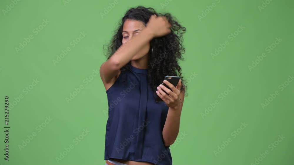 Young beautiful Hispanic businesswoman using phone Young beautiful Hispanic businesswoman using phone