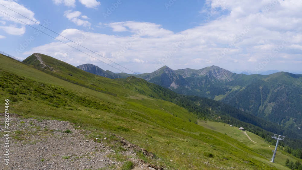 Fototapeta premium hiking path on sloped hills with a view on mountain ridges