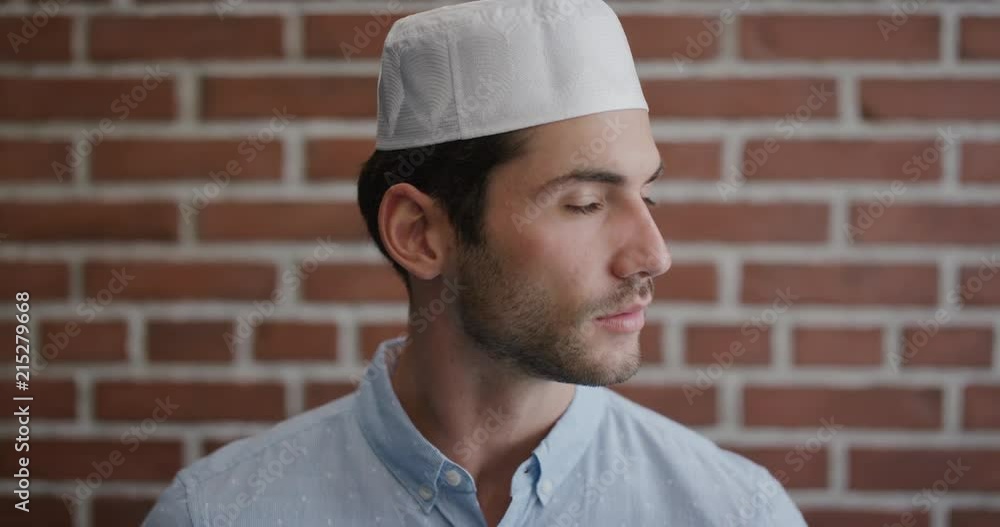 portrait attractive young muslim man turns looking pensive turns head confident independent businessman wearing kufi hat slow motion portrait attractive young muslim man turns looking pensive turns head confident independent businessman wearing kufi hat slow motion