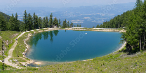 water winter reserves lake from above with view on austrian villages