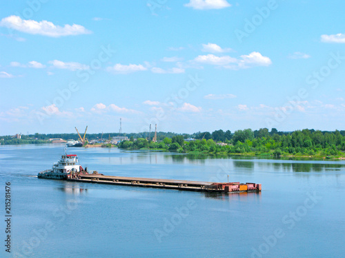 River shipping. Barge on the Volga river in vicinity of Kimry town, Russia. In the rear background is the river port of Kimry.