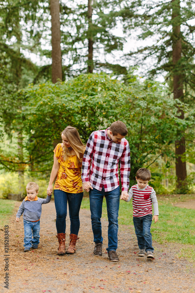 Happy Family Walking in Park during the Fall Happy Family Walking in Park during the Fall