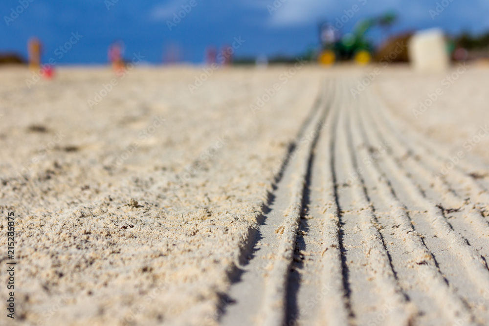 Naklejka premium Traces of work on the sand
