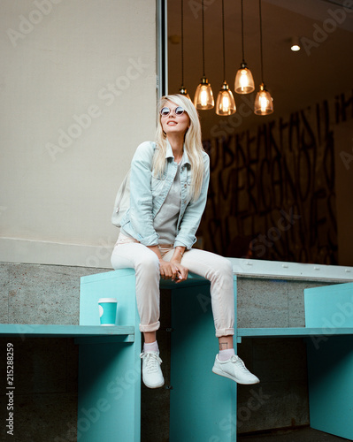 Stylish woman posing on bench photo