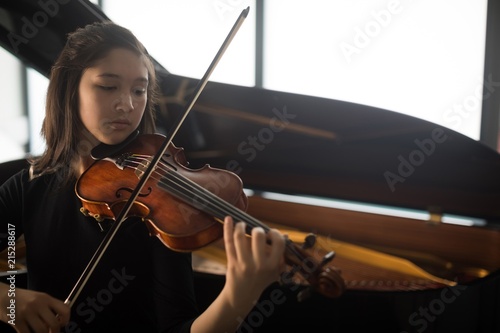 Schoolgirl playing violin in music school photo