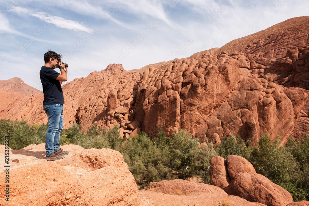 Photographer taking landscape photos in the Tamlalt cliffs Photographer taking landscape photos in the Tamlalt cliffs