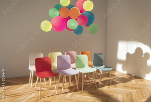 Floating colorful object above group of seats photo