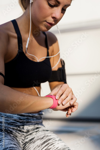 Sporty woman looking at a chronometer photo