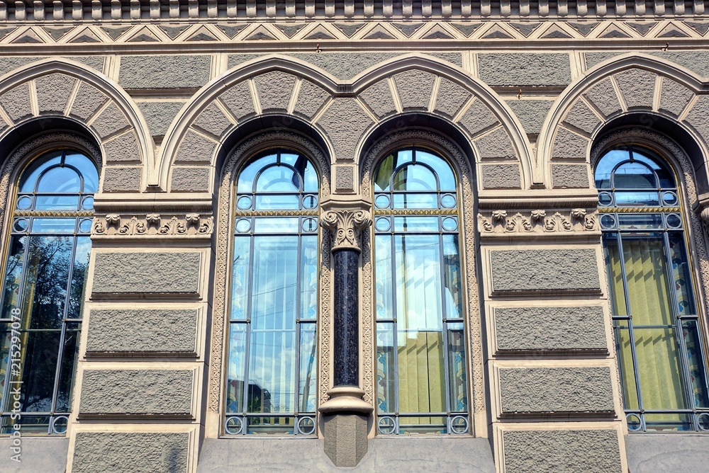 Fototapeta premium old beautiful windows on a gray stone wall