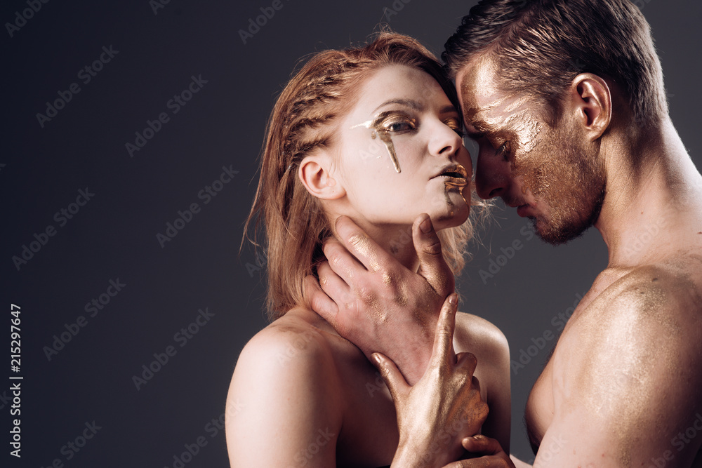 Erotica concept. erotica with couple having golden body and touching each other, copy space. Erotica concept. erotica with couple having golden body and touching each other, copy space.