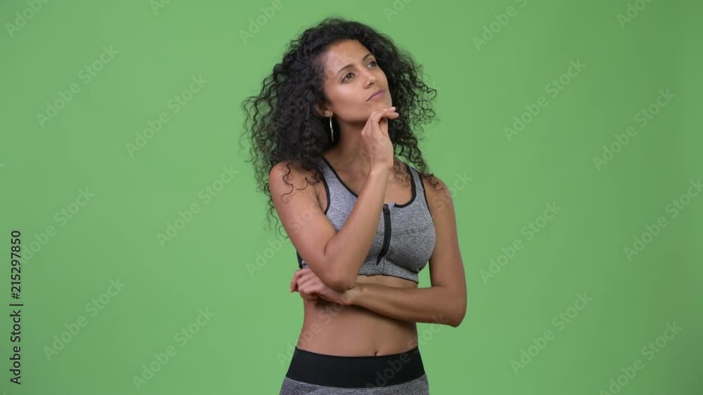 Young beautiful Hispanic woman thinking ready for gym Young beautiful Hispanic woman thinking ready for gym