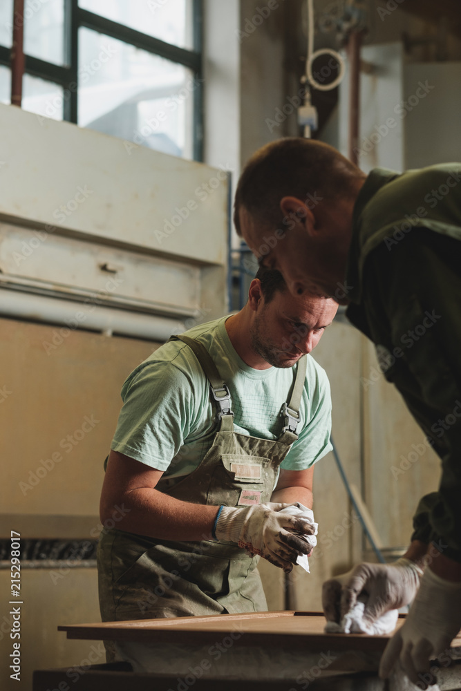 Man In The Uniform Working At The Furniture Factory Man In The Uniform Working At The Furniture Factory