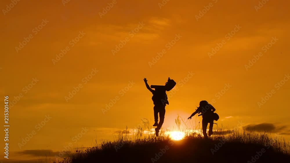 two men tourists hikers silhouette go to the mountains sunset travel slow motion video lifestyle. Traveler successful young men walking on top of Mountain and waiting for sunrise. travel tourists in two men tourists hikers silhouette go to the mountains sunset travel slow motion video lifestyle. Traveler successful young men walking on top of Mountain and waiting for sunrise. travel tourists in