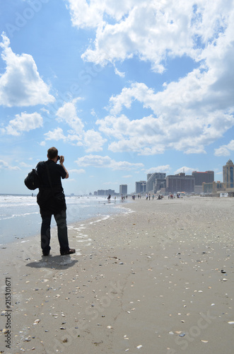 Tourist taking pictures of the Atlantic city shore