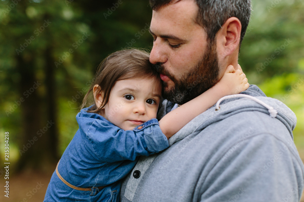 Adorable Little Girl Cuddles on Dad's Shoulder Adorable Little Girl Cuddles on Dad's Shoulder