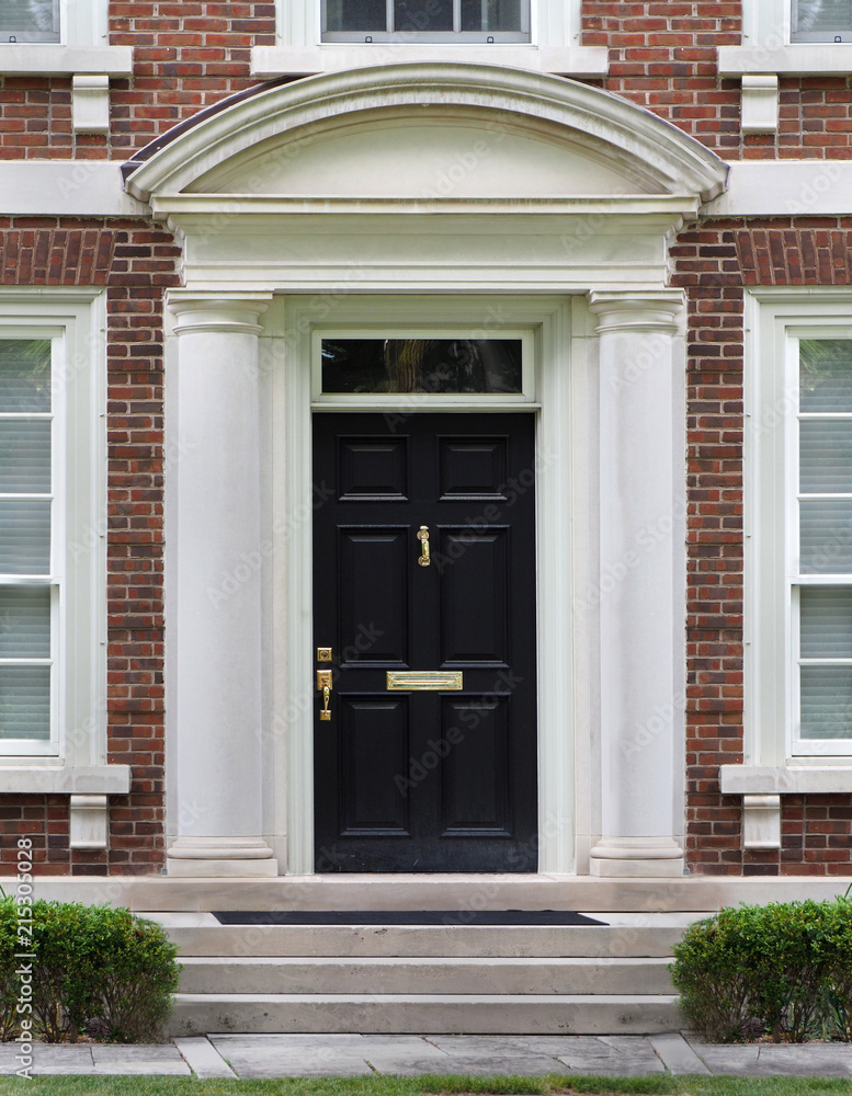 elegant front door with stone frame