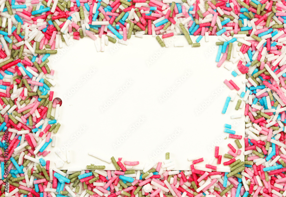 Obraz premium White paper with colorful sprinkles around, party design element. Festive holiday background with copy space. Celebration concept.