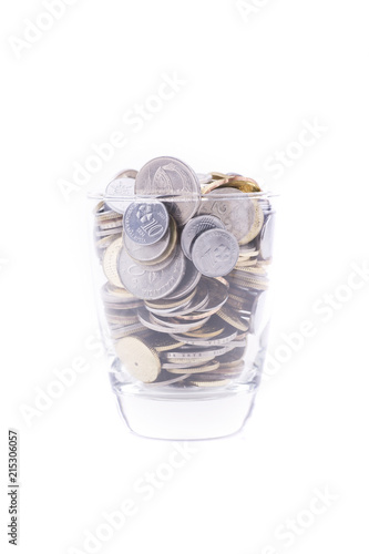 Money concept, coins inside or with the glass isolated over white background