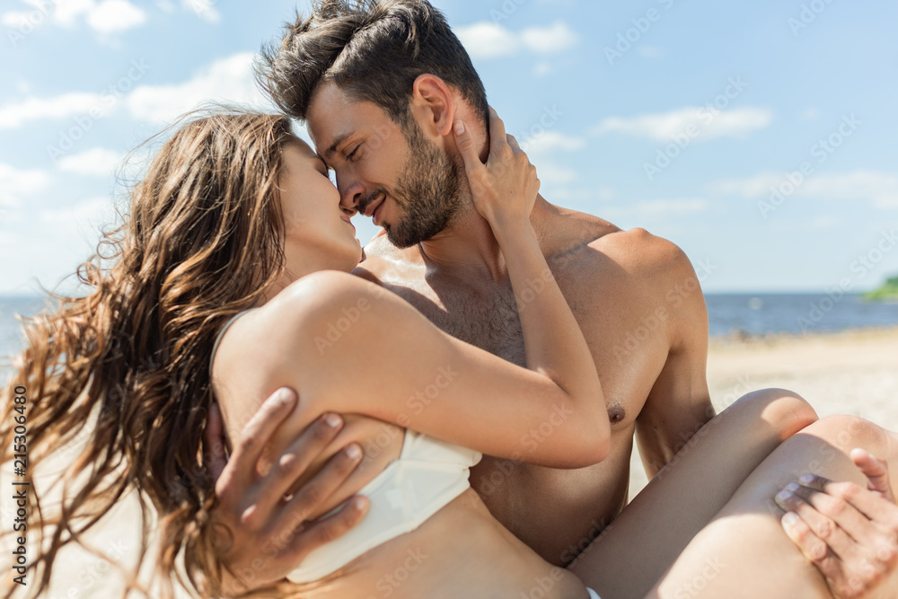 happy boyfriend hugging and holding girlfriend on hands on resort happy boyfriend hugging and holding girlfriend on hands on resort