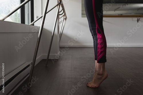Young woman standing on tip toe